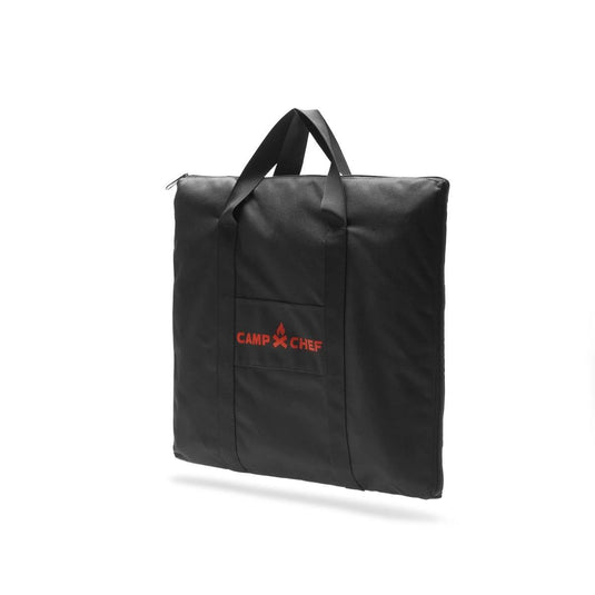 The Camp Chef Griddle Bag - 1 Burner is a black, weather-resistant square bag with two handles, a front pocket, and the red Camp Chef logo with fire icon—perfect for protecting your griddle. Photographed on a white background.