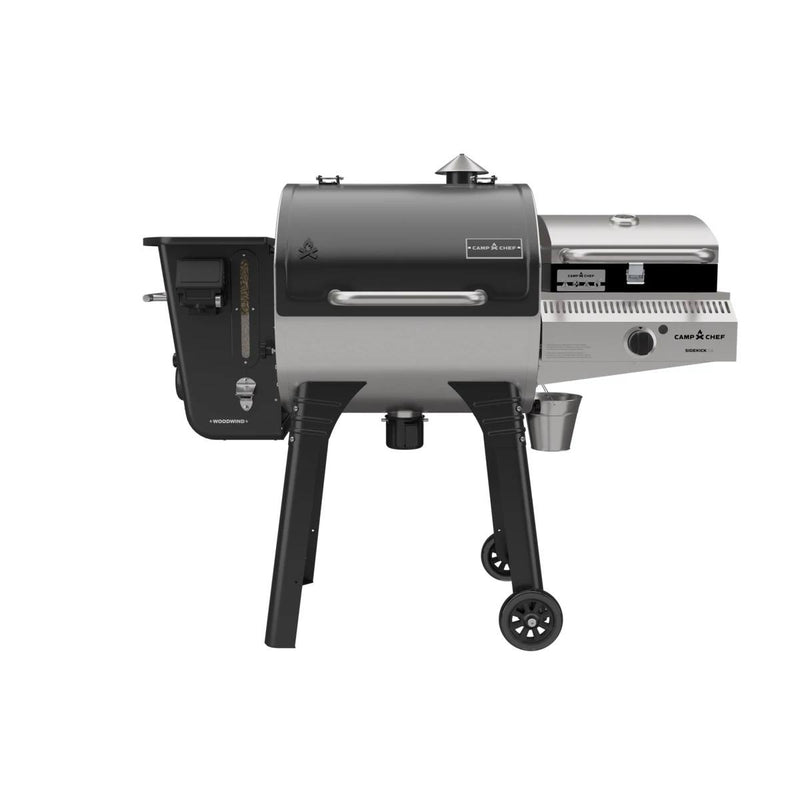 Load image into Gallery viewer, The Camp Chef Woodwind 24 is a black and silver outdoor pellet grill featuring a WIFI controller, side attachment, chimney, control panel, and two wheels for easy mobility, displayed on a white background.
