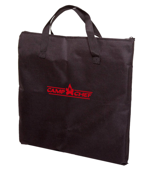 The Camp Chef Multipurpose Carry Bag is black with handles and a zipper, designed to fit fry griddles or a grill box, featuring the red Camp Chef logo and flame graphic on the front.