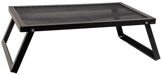 The Camp Chef Lumberjack Over Fire Grill 16”X24” is a black, rectangular grill with foldable legs and a mesh surface, perfect for convenient campfire cooking and easy portability on outdoor adventures.