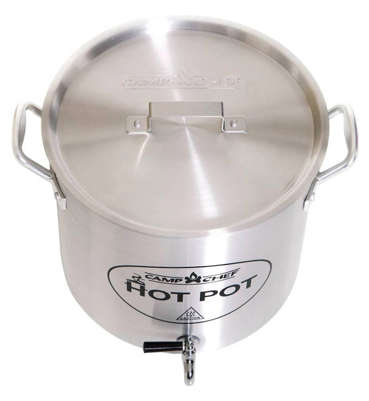 The Camp Chef Hot Water Pot is a large stainless steel container with two side handles, a lid, and a bottom spigot—ideal as an outdoor beverage dispenser for campsite hot drinks. The front label reads "Hot Water Pot.
