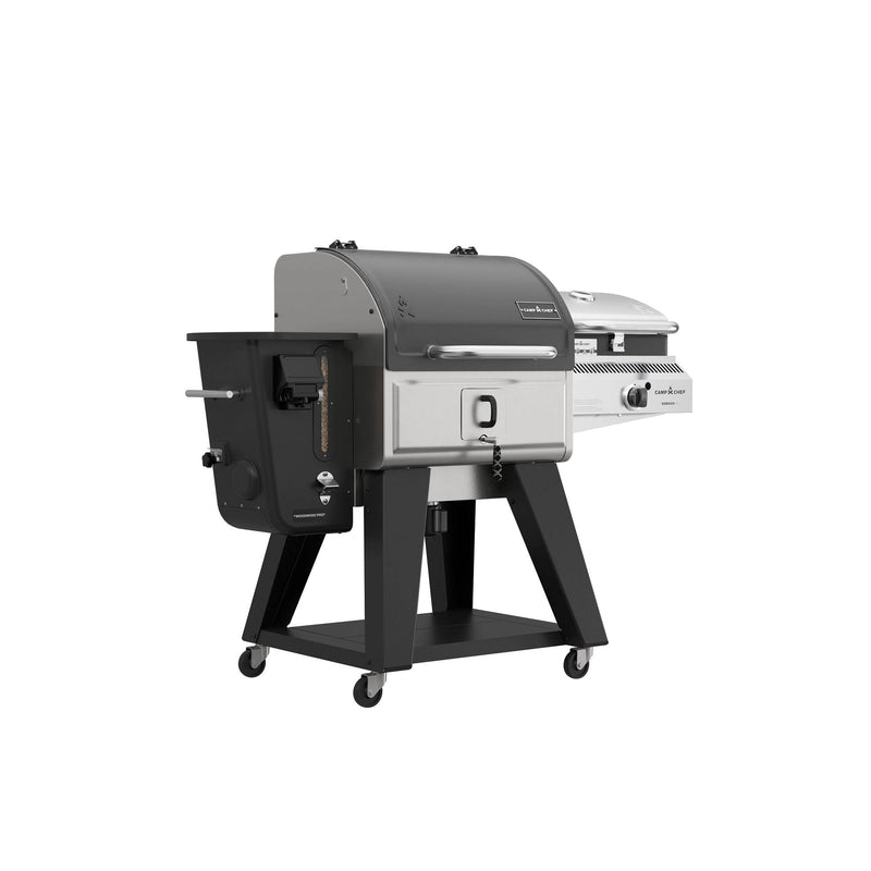 Load image into Gallery viewer, The Camp Chef Woodwind Pro 24 is a dual-function outdoor grill with black and silver design, separate charcoal and gas compartments, built-in Smoke Box for cold smoking with wood pellets, plus side handles and wheels for easy mobility.
