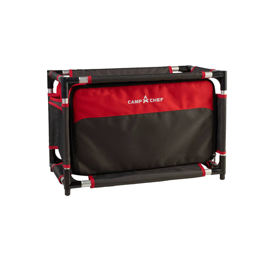 The Camp Chef Sherpa Table & Organizer is a collapsible black and red camp table with a sturdy frame and fabric compartments, perfect as an outdoor cooking station or gear organizer on camping adventures.