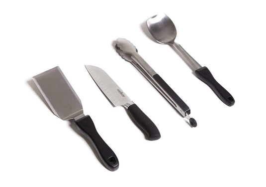 The Camp Chef 5 Piece All Purpose Chef Set features four portable utensils—spatula, chef’s knife, tongs, and serving spoon with black handles—arranged side by side on a white background for convenient camp cooking.