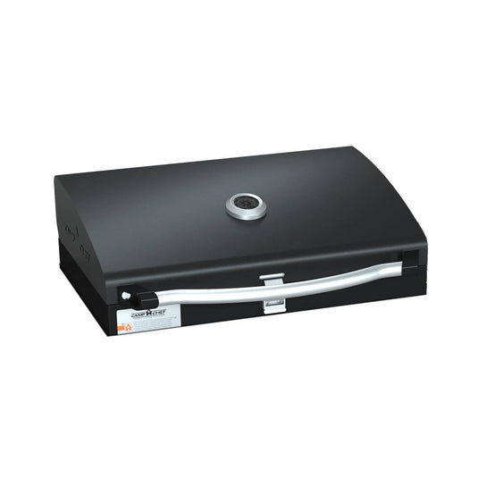 The Camp Chef BBQ Grill Boxes 16 is a black tabletop grill featuring cast iron grates, a curved silver handle, a built-in temperature gauge on the lid, and a front latch, shown against a white background. Black