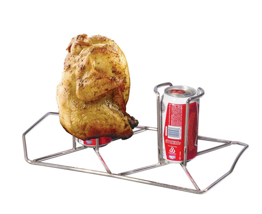 A whole chicken sits upright on an open soda can in the Camp Chef Beer Can Chicken Holder, ideal for patio grilling. The sturdy rack holds another empty can beside the bird for added convenience.