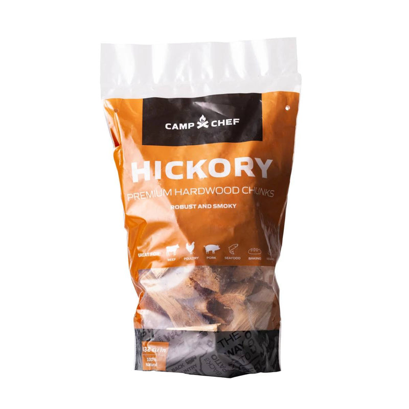 Load image into Gallery viewer, A clear, orange Camp Chef bag labeled Wood Chunks contains hardwood pieces for grilling and smoking. The package features food icons and text about a robust, smoky flavor—ideal for any hardwood grill.
