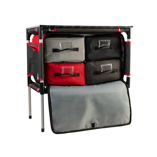 The Camp Chef Sherpa Table & Organizer features four fabric drawers in red, black, and gray, a sturdy metal frame, and a fold-down front cover—ideal for keeping your gear organized at campsites or outdoor cooking stations.