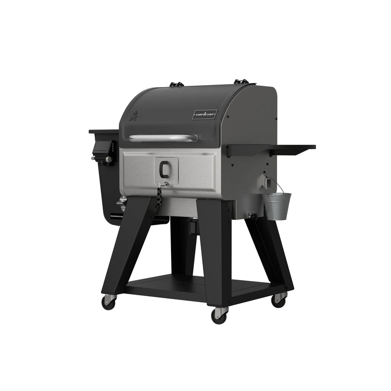 Load image into Gallery viewer, The Camp Chef Woodwind Pro 24 is a black and silver outdoor smoker grill on wheels, featuring a side shelf, Smoke Box for cold smoking, front handle, and attached metal bucket.
