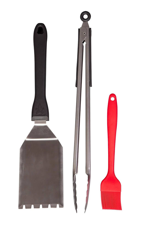 The Camp Chef BBQ Tool Set includes a metal spatula with a black handle, stainless steel tongs with black grips, and a red silicone basting brush—must-have grilling accessories for any barbecue.