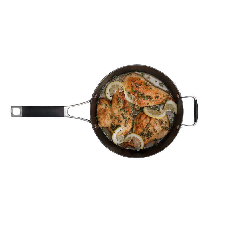 Load image into Gallery viewer, A top-down view of cooked chicken breasts with lemon and herbs in a Heritage Skillets pan by Camp Chef highlights the searing performance and quality craftsmanship of this cast iron cookware.
