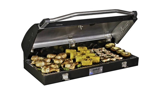 The Camp Chef BBQ Grill Box 14 - 2 Burner, with its cast iron grate and open lid, cooks chicken drumsticks, corn on the cob, bacon-wrapped treats, eggplant slices, and veggies to perfection.