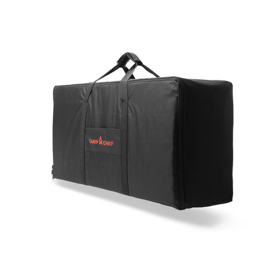 The Carry Bag 14 by Camp Chef is a large black rectangular bag with handles for 2-burner systems, featuring a red Camp Chef logo on the front pocket, shown against a plain white background.