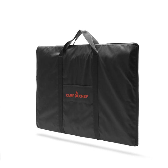 The Camp Chef Griddle Bag 16 - 2 Burner is a black rectangular padded case with handles, a front pocket, and the red Camp Chef logo. It's weather-resistant and ideal for carrying your griddle or other portable outdoor gear.