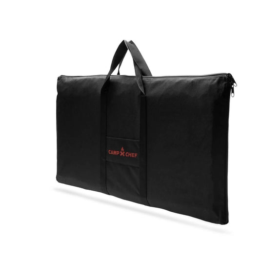 The Camp Chef Griddle Bag 16 - 3 Burner is a black, rectangular carry bag with two handles, a small front pocket featuring the red Camp Chef logo, and a zippered design with a weather-resistant liner. Shown on a white background.