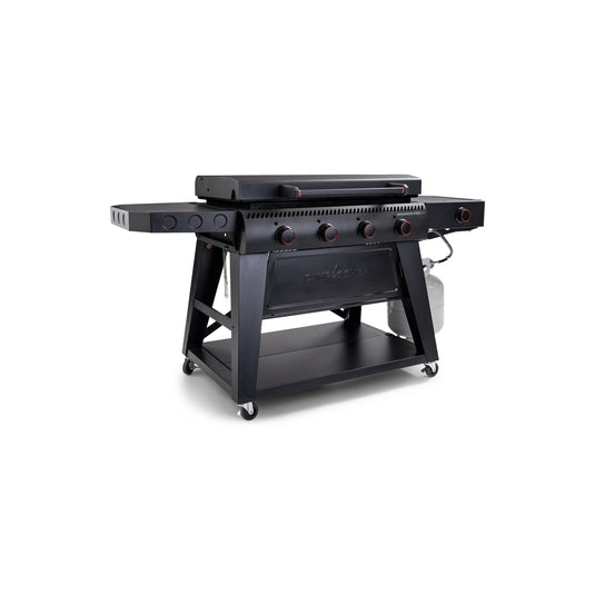 The Camp Chef Gridiron Pro Flat Top Grill is a large black outdoor propane griddle with four red knobs, side shelves, lower storage shelf, propane tank, and wheels—ideal for your outdoor cooking system.