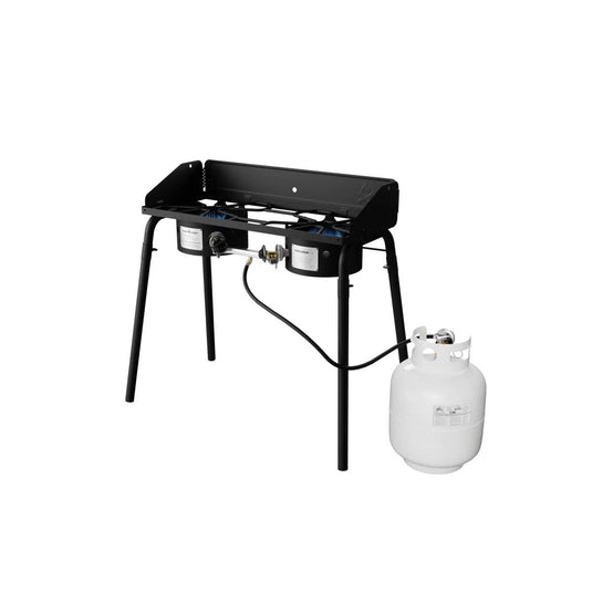 The Camp Chef Explorer is a black, two-burner cooking system on four legs, shown with a white propane tank attached—ideal for outdoor cooking and camping.